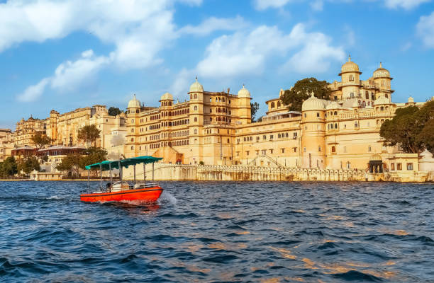 City Palace Udaipur Rajasthan India as seen from a boat on lake Pichola